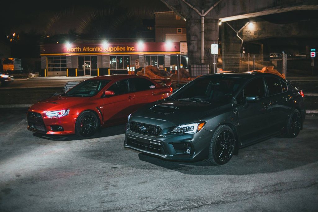 two sports cars at night